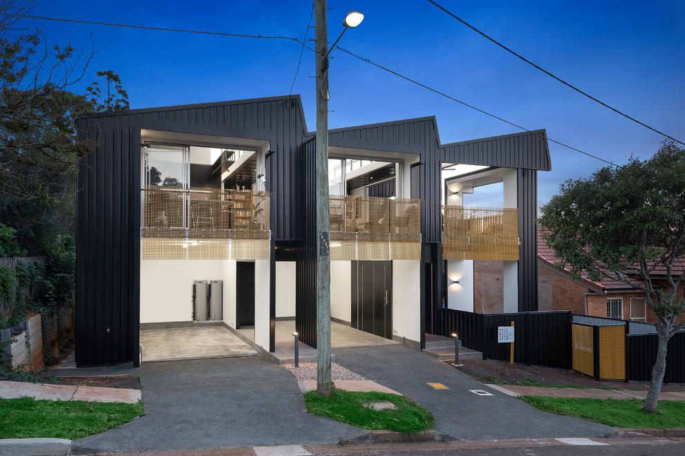This is an example of a large industrial two-storey black house exterior in Other with metal siding.