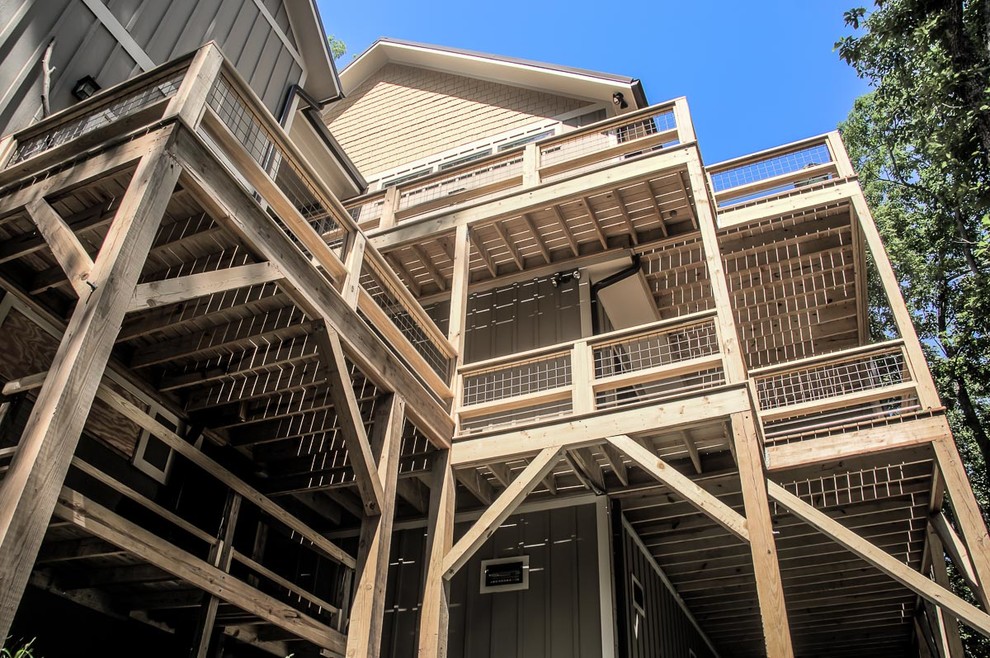 Deck - mid-sized transitional three-story and backyard mixed siding brown deck idea with no cover