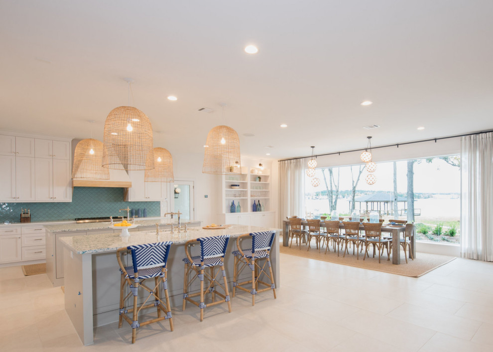 Design ideas for a large beach style u-shaped eat-in kitchen in Houston with a drop-in sink, white cabinets, recycled glass benchtops, blue splashback, mosaic tile splashback, stainless steel appliances, multiple islands and multi-coloured benchtop.