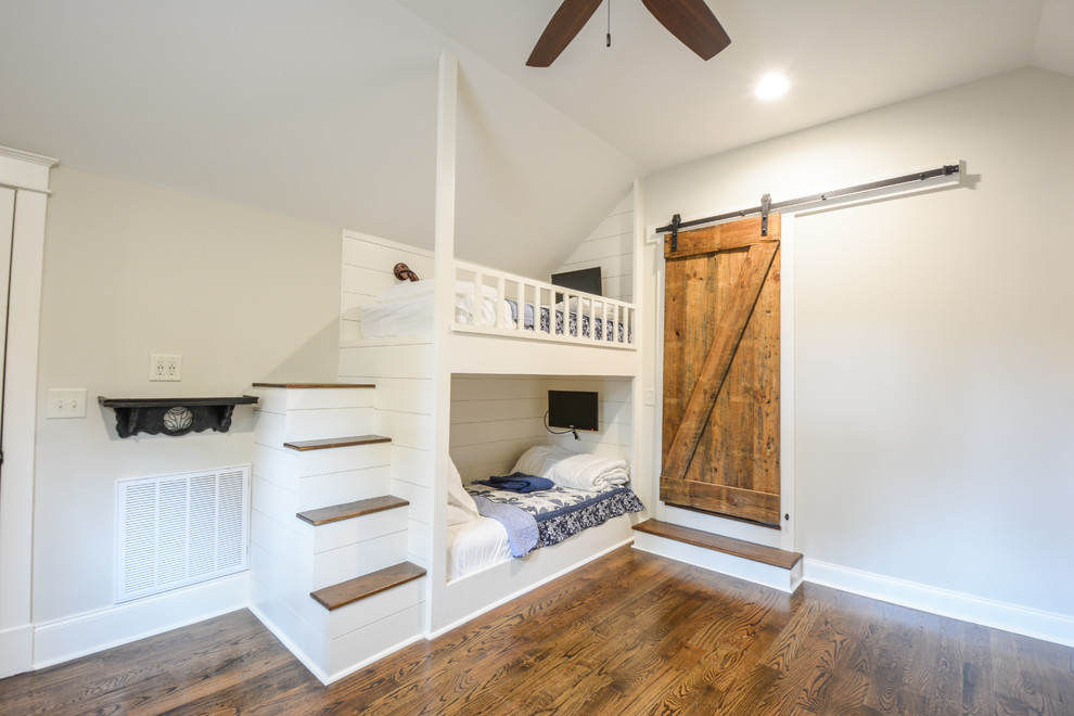 Mid-sized arts and crafts loft-style bedroom in Atlanta with beige walls, dark hardwood floors and brown floor.