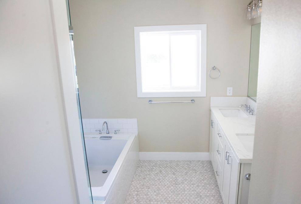 Photo of a large country kids bathroom in Orange County with shaker cabinets, white cabinets, a freestanding tub, a corner shower, a two-piece toilet, white tile, ceramic tile, beige walls, marble floors, an undermount sink, granite benchtops, white floor, a hinged shower door, white benchtops, a double vanity and a built-in vanity.