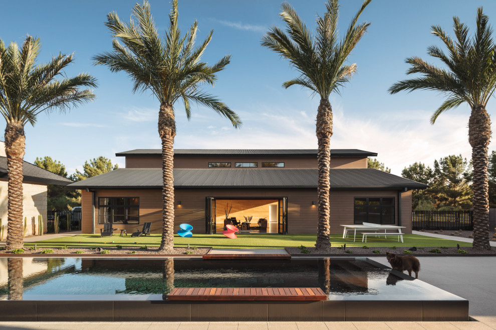 Inspiration for a large contemporary courtyard rectangular infinity pool in Phoenix with with a pool and concrete slab.