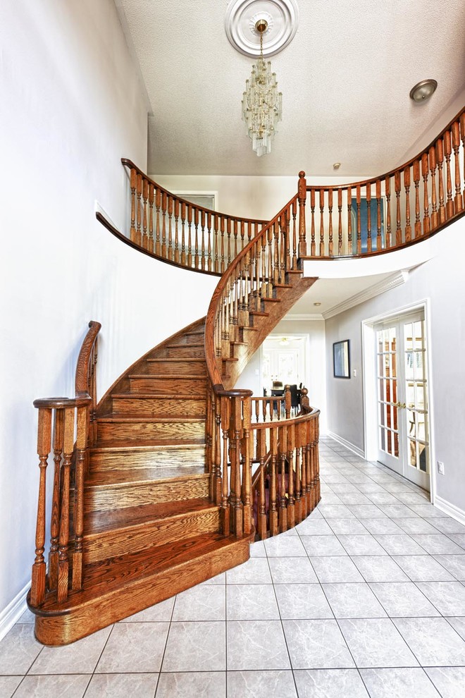 Inspiration for a mid-sized timeless wooden curved wood railing staircase remodel in Orange County with painted risers
