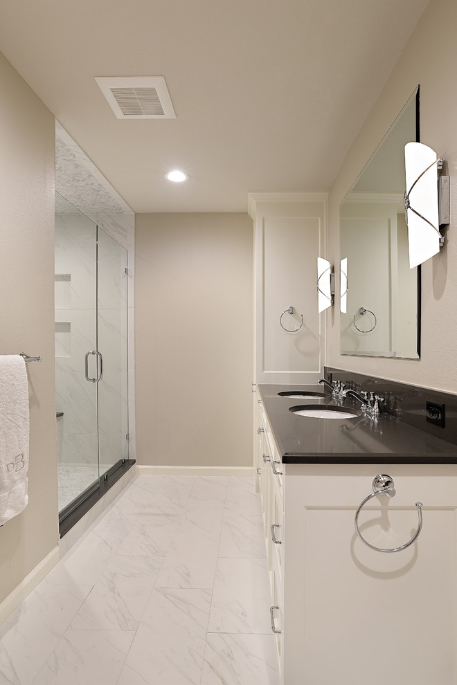 Mid-sized traditional master bathroom in Dallas with shaker cabinets, white cabinets, an alcove shower, a two-piece toilet, black and white tile, marble, beige walls, porcelain floors, an undermount sink, engineered quartz benchtops, white floor and a hinged shower door.