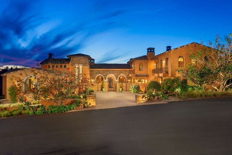 Large mediterranean three-storey exterior in San Diego with stone veneer and a gable roof.