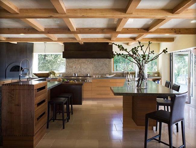 Photo of a large contemporary eat-in kitchen in San Francisco with a double-bowl sink, flat-panel cabinets, light wood cabinets, quartz benchtops, multi-coloured splashback, black appliances, limestone floors and multiple islands.