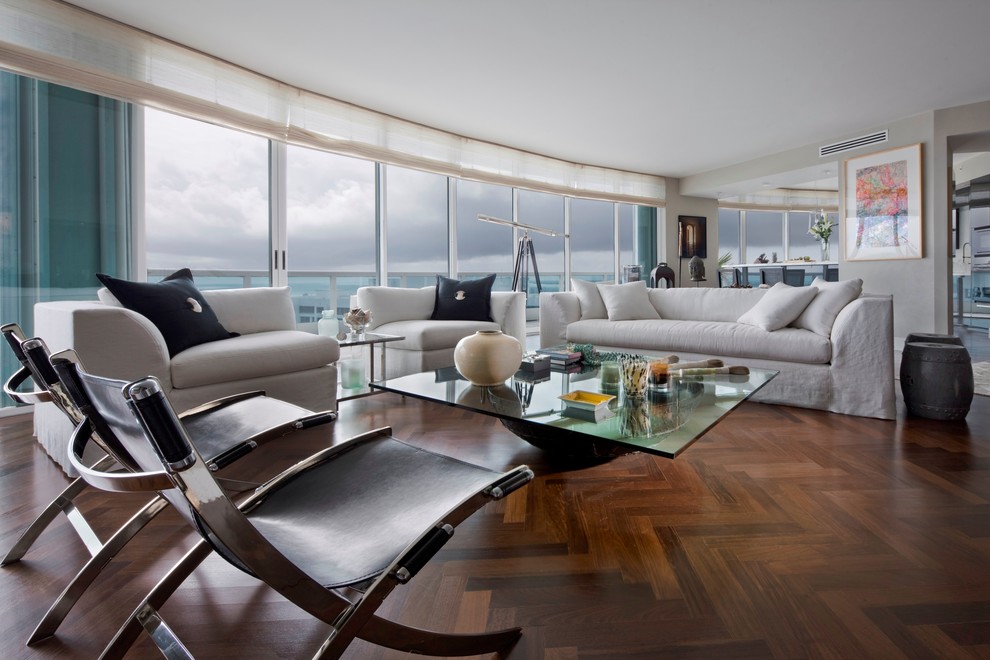 Photo of a large modern formal open concept living room in Miami with dark hardwood floors and grey walls.