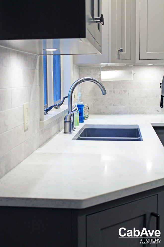 Enclosed kitchen - small transitional l-shaped vinyl floor and brown floor enclosed kitchen idea with an undermount sink, recessed-panel cabinets, gray cabinets, quartz countertops, white backsplash, subway tile backsplash, stainless steel appliances and no island