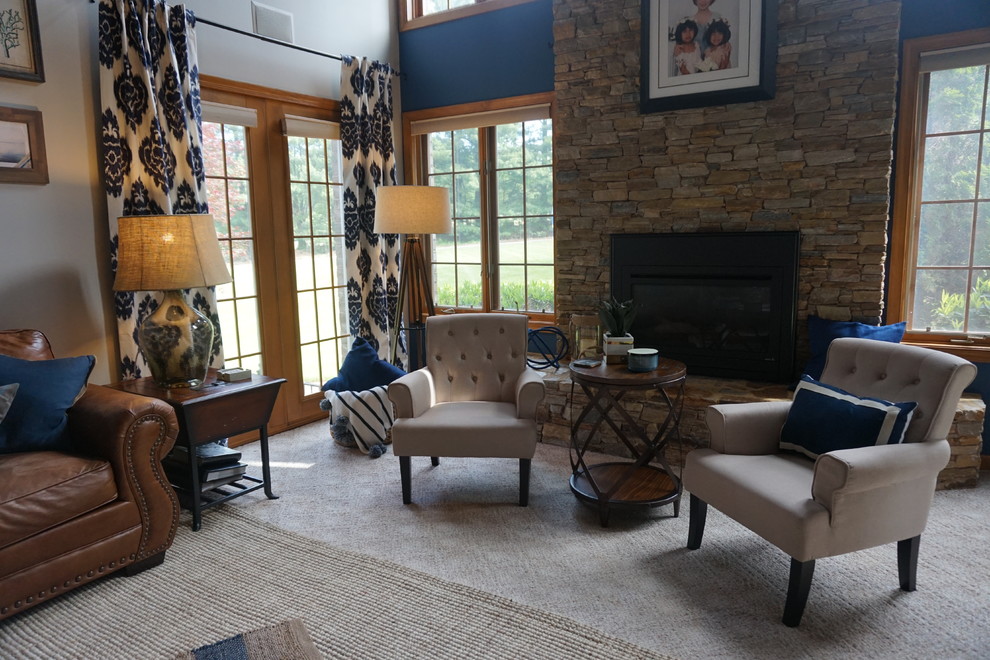 This is an example of a large beach style enclosed family room in Baltimore with multi-coloured walls, carpet, a standard fireplace, a stone fireplace surround, a wall-mounted tv and beige floor.