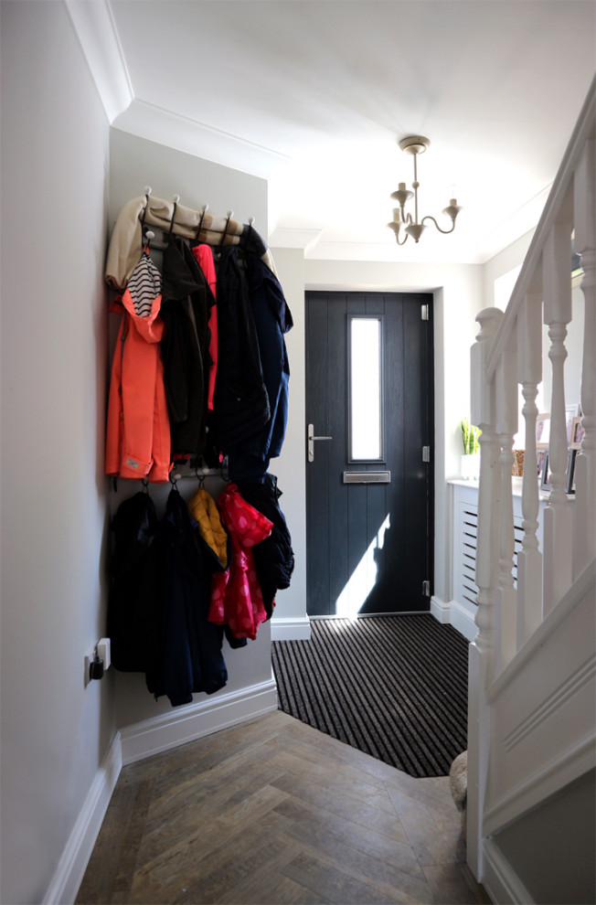 Inspiration for a mid-sized modern hallway in Hertfordshire with grey walls, vinyl floors and brown floor.
