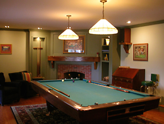 Inspiration for a mid-sized transitional underground carpeted basement remodel in Boston with white walls, a standard fireplace and a brick fireplace