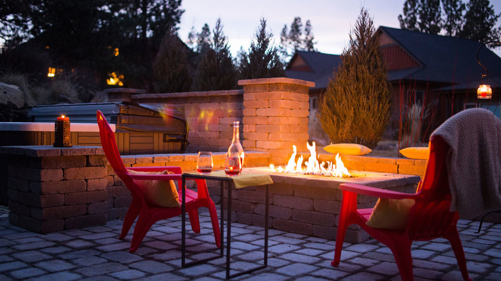 Large trendy backyard concrete paver patio photo with a fire pit and no cover