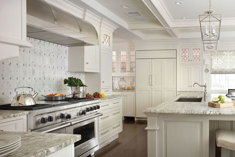 Inspiration for a large transitional l-shaped dark wood floor kitchen pantry remodel in Denver with a drop-in sink, shaker cabinets, white cabinets, laminate countertops, multicolored backsplash, mosaic tile backsplash, stainless steel appliances and an island
