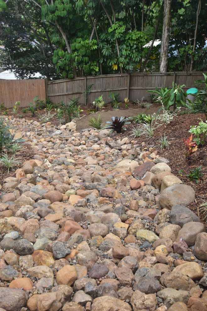 Design ideas for a large tropical backyard partial sun garden in Brisbane with a garden path and gravel.