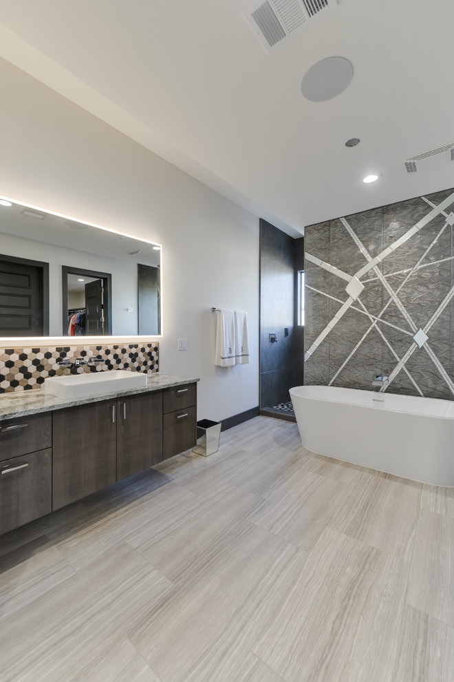 Photo of a mid-sized modern master bathroom in Austin with glass-front cabinets, medium wood cabinets, a freestanding tub, an open shower, a one-piece toilet, brown tile, marble, white walls, porcelain floors, a vessel sink, marble benchtops, brown floor, an open shower and multi-coloured benchtops.
