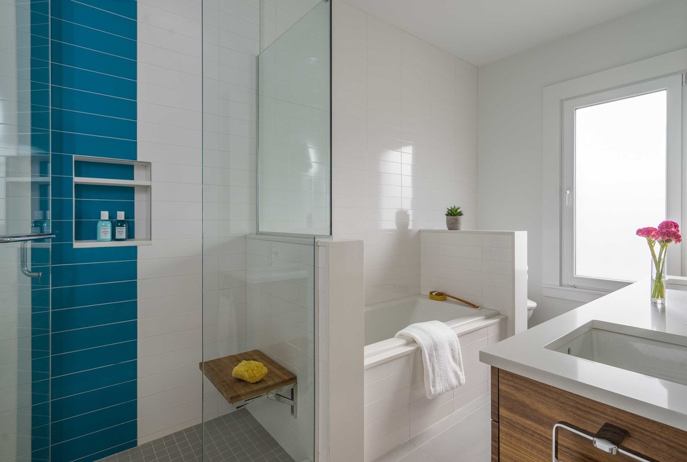 Mid-sized modern master bathroom in Boston with flat-panel cabinets, medium wood cabinets, a drop-in tub, white tile, porcelain floors, an undermount sink, engineered quartz benchtops, grey floor and white benchtops.