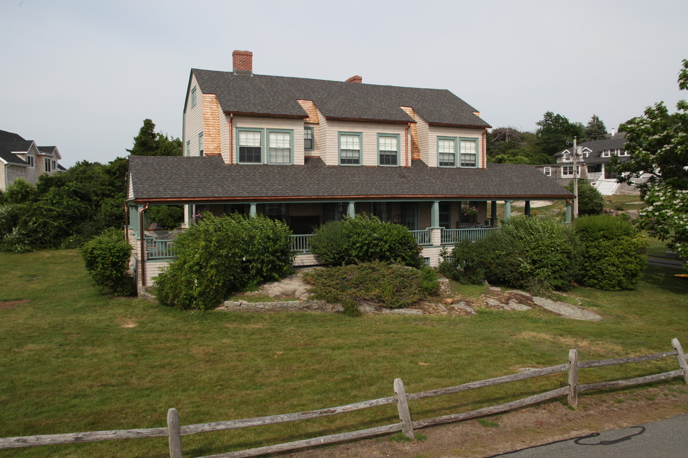 Photo of a large traditional three-storey grey exterior in Boston with wood siding and a clipped gable roof.