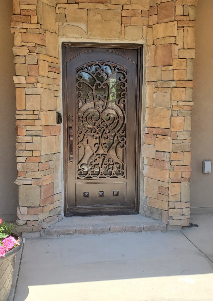 Inspiration for a mid-sized rustic entryway remodel in Albuquerque with a brown front door