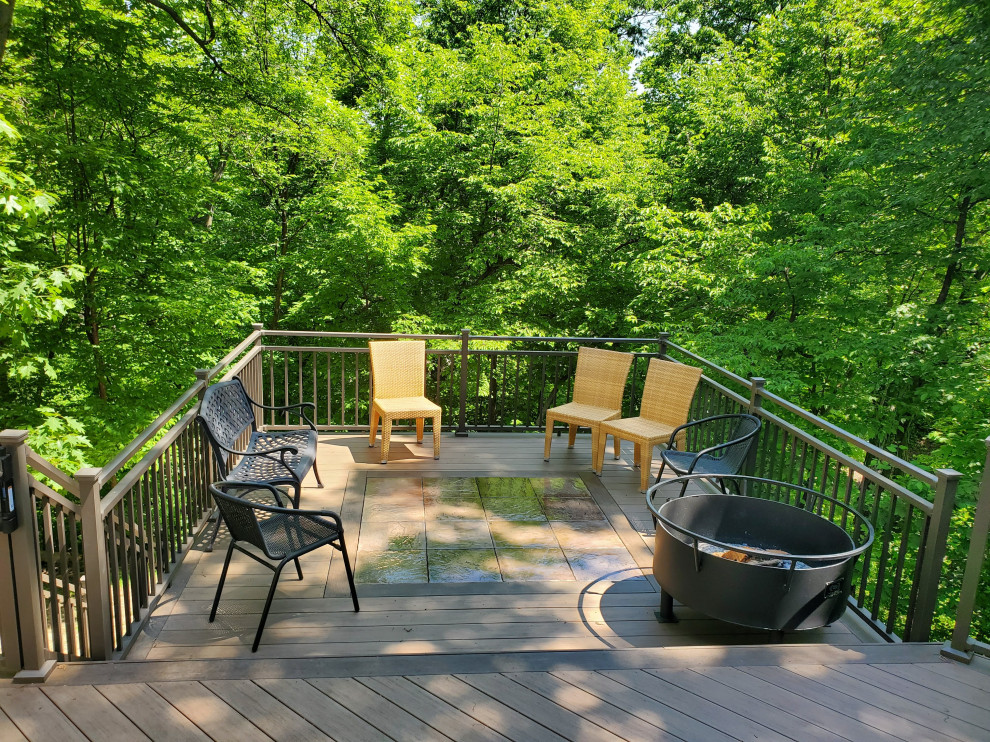 Inspiration for a large backyard ground level metal railing deck remodel with no cover