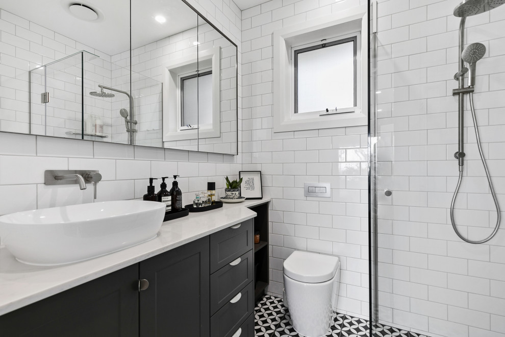 Inspiration for a large master bathroom in Geelong with shaker cabinets, a corner shower, ceramic floors, engineered quartz benchtops, a hinged shower door, a niche, a single vanity and a built-in vanity.