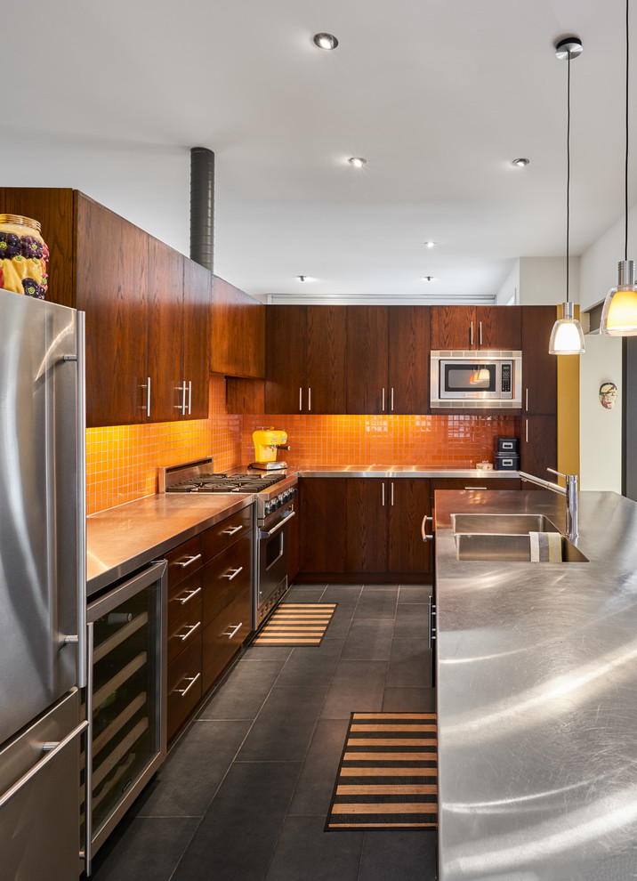 Contemporary l-shaped open plan kitchen in Ottawa with a double-bowl sink, flat-panel cabinets, dark wood cabinets, stainless steel benchtops, orange splashback, mosaic tile splashback, stainless steel appliances, with island and black floor.