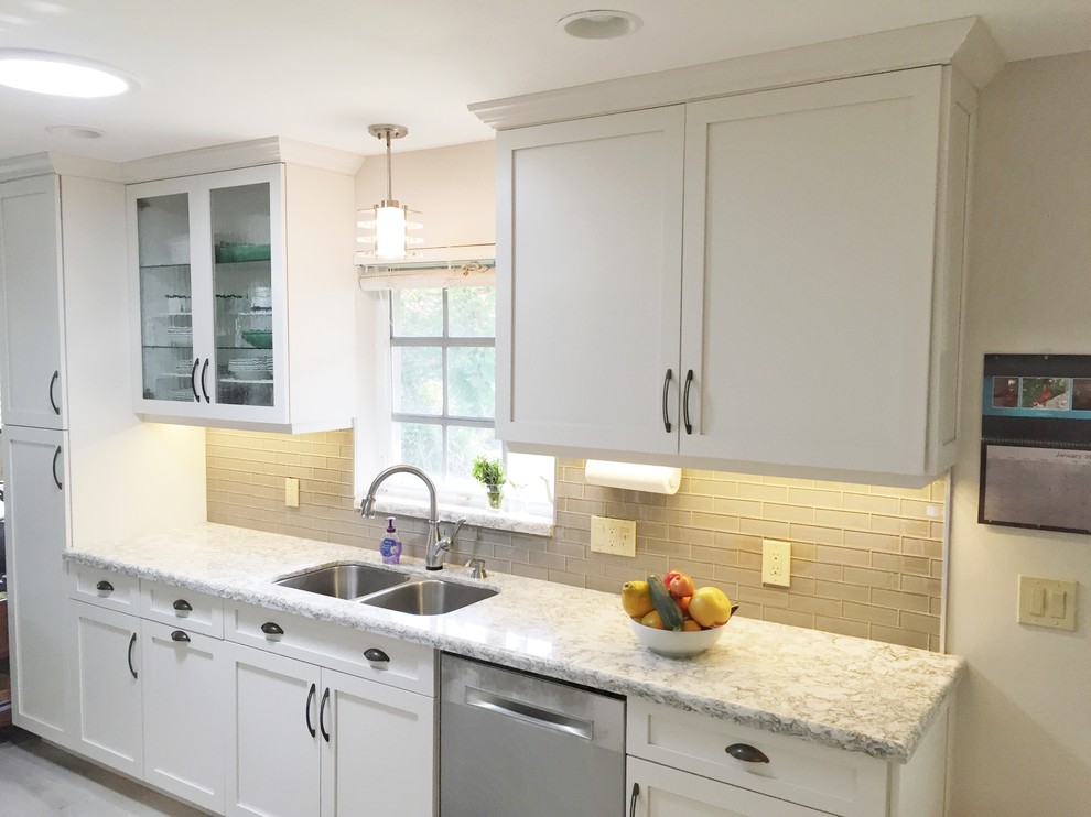 Example of a mid-sized transitional home design design in Miami with a double-bowl sink, shaker cabinets, white cabinets, gray backsplash, glass tile backsplash, stainless steel appliances and no island