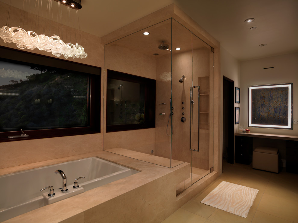 Large contemporary master bathroom in Los Angeles with flat-panel cabinets, dark wood cabinets, marble benchtops, beige tile, stone tile, white walls, limestone floors and an undermount tub.