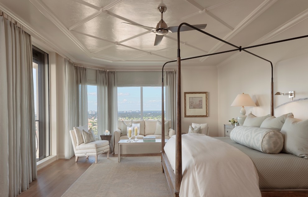 Inspiration for a large traditional master bedroom in Miami with beige walls and medium hardwood floors.
