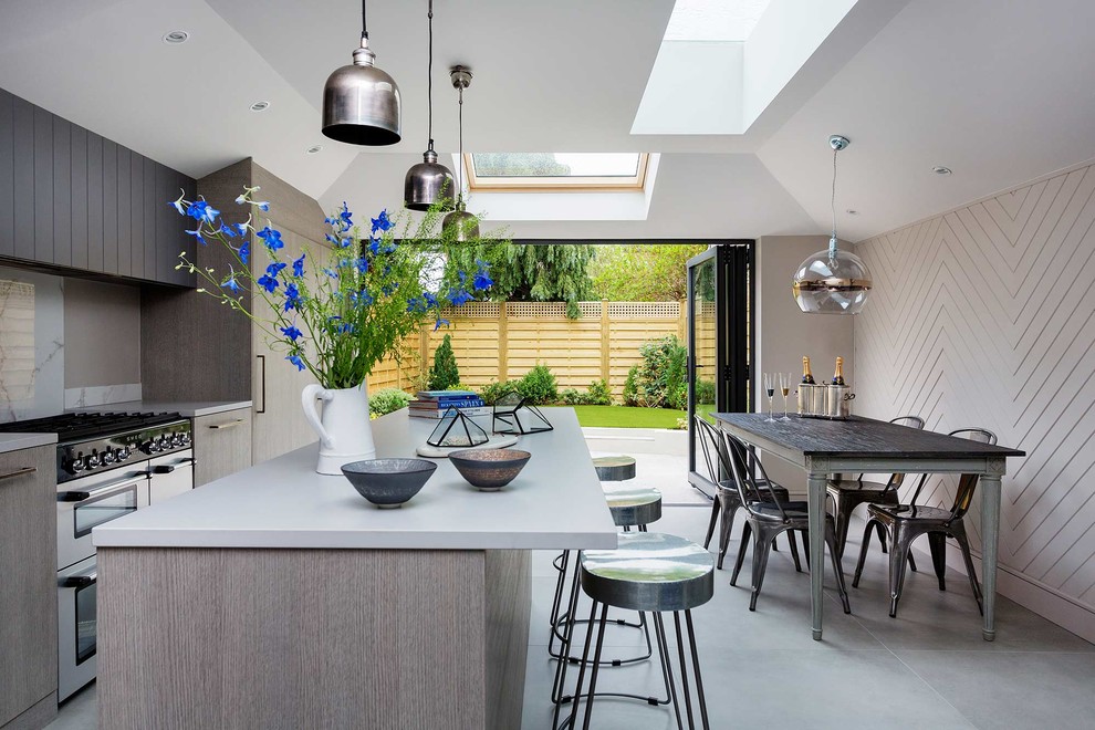 Mid-sized contemporary eat-in kitchen in London with an undermount sink, glass-front cabinets, with island and grey floor.