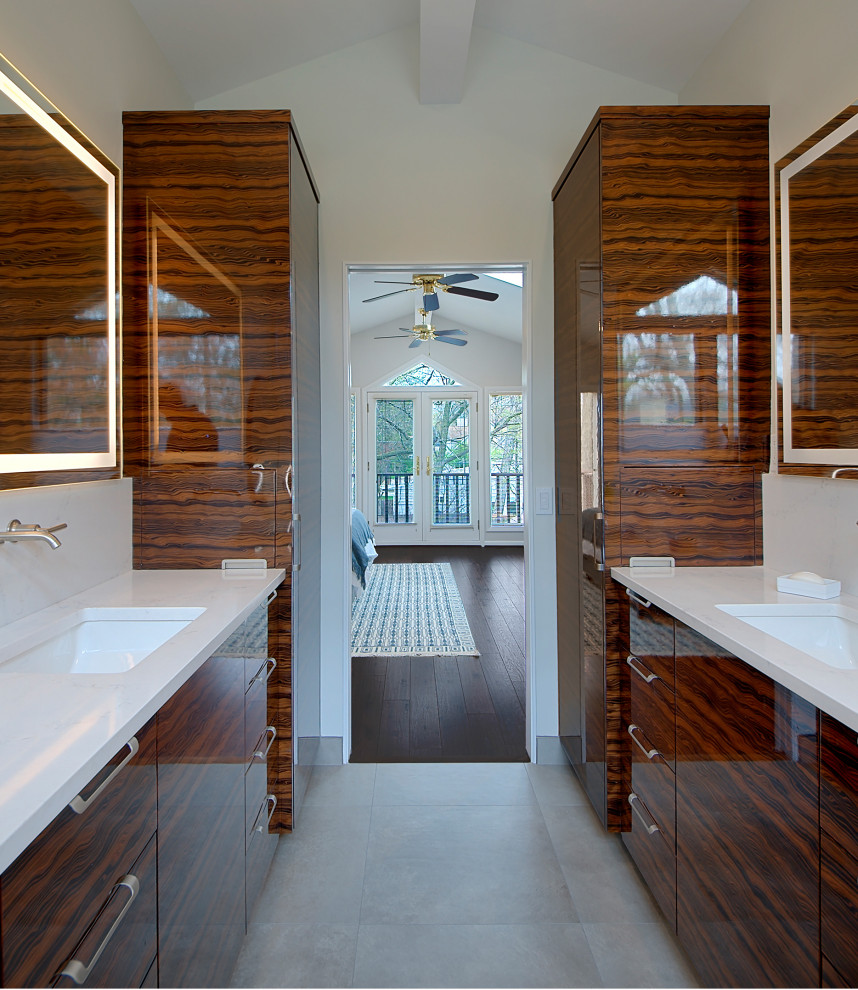 Photo of a medium sized modern ensuite bathroom in Chicago with flat-panel cabinets, brown cabinets, an alcove shower, porcelain flooring, a submerged sink, engineered stone worktops, grey floors, a hinged door, white worktops, double sinks, a built in vanity unit and a vaulted ceiling.