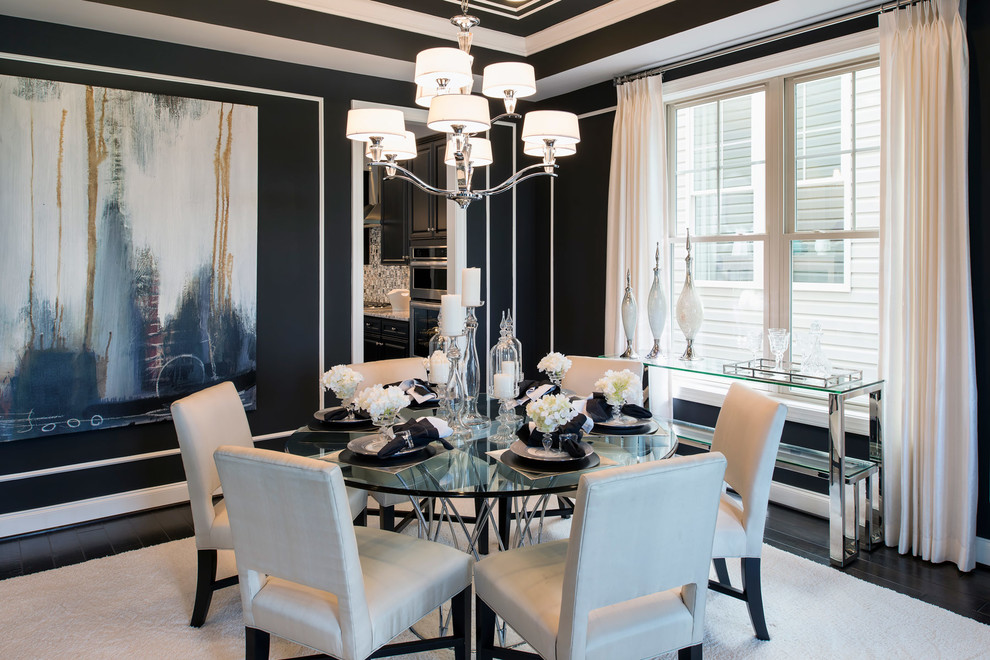 This is an example of a transitional separate dining room in DC Metro with black walls and dark hardwood floors.