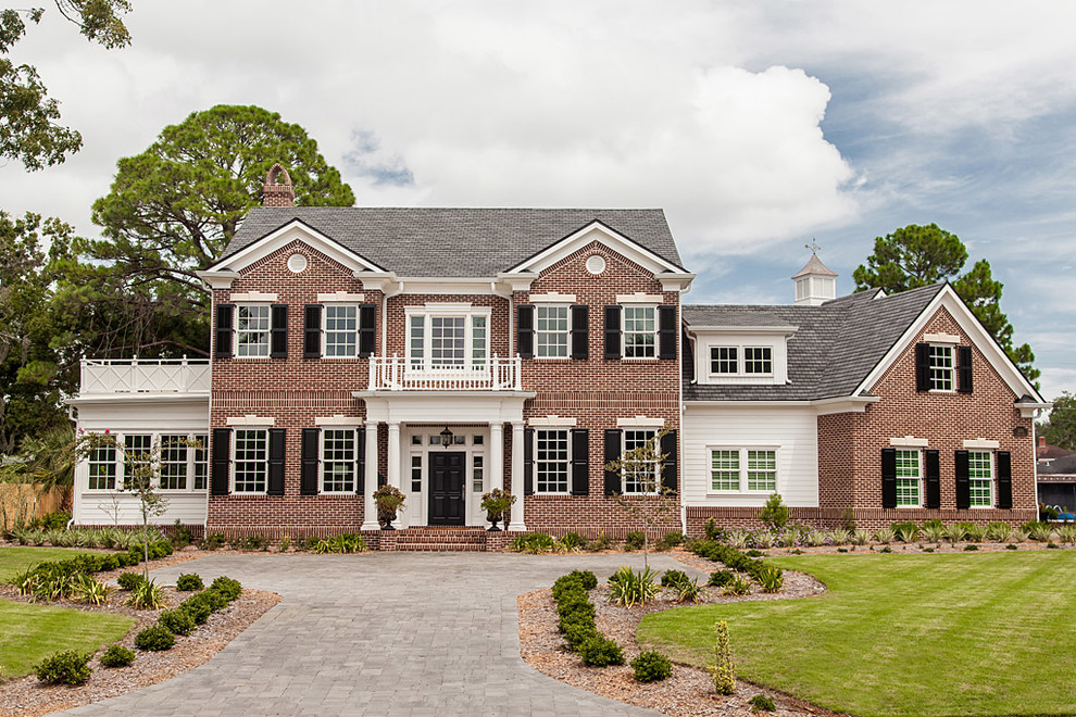 Design ideas for a large arts and crafts two-storey brick red exterior in Jacksonville.
