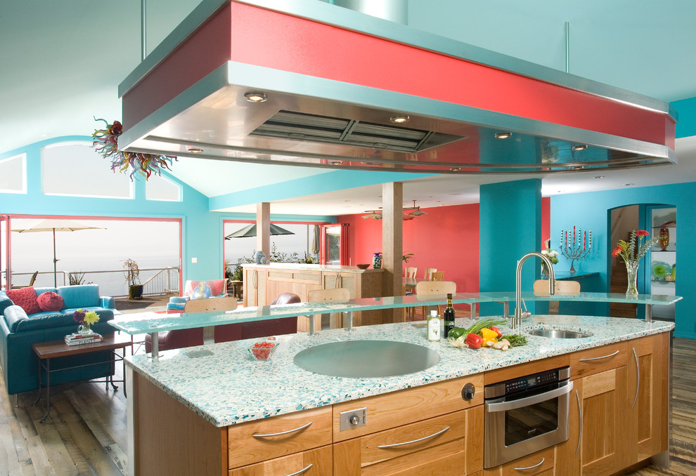 Large contemporary single-wall open plan kitchen in Seattle with an undermount sink, open cabinets, light wood cabinets, recycled glass benchtops, blue splashback, subway tile splashback, stainless steel appliances, medium hardwood floors, with island and turquoise benchtop.