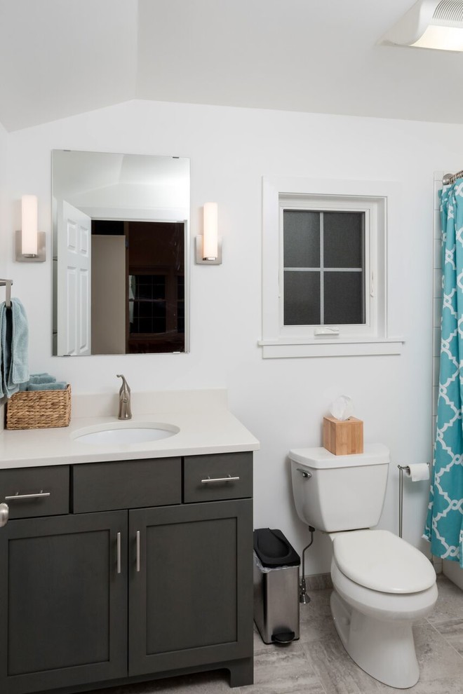 Inspiration for a small transitional 3/4 gray tile, white tile and subway tile ceramic tile and gray floor alcove bathtub remodel with shaker cabinets, gray cabinets, a two-piece toilet, white walls, an undermount sink and quartz countertops