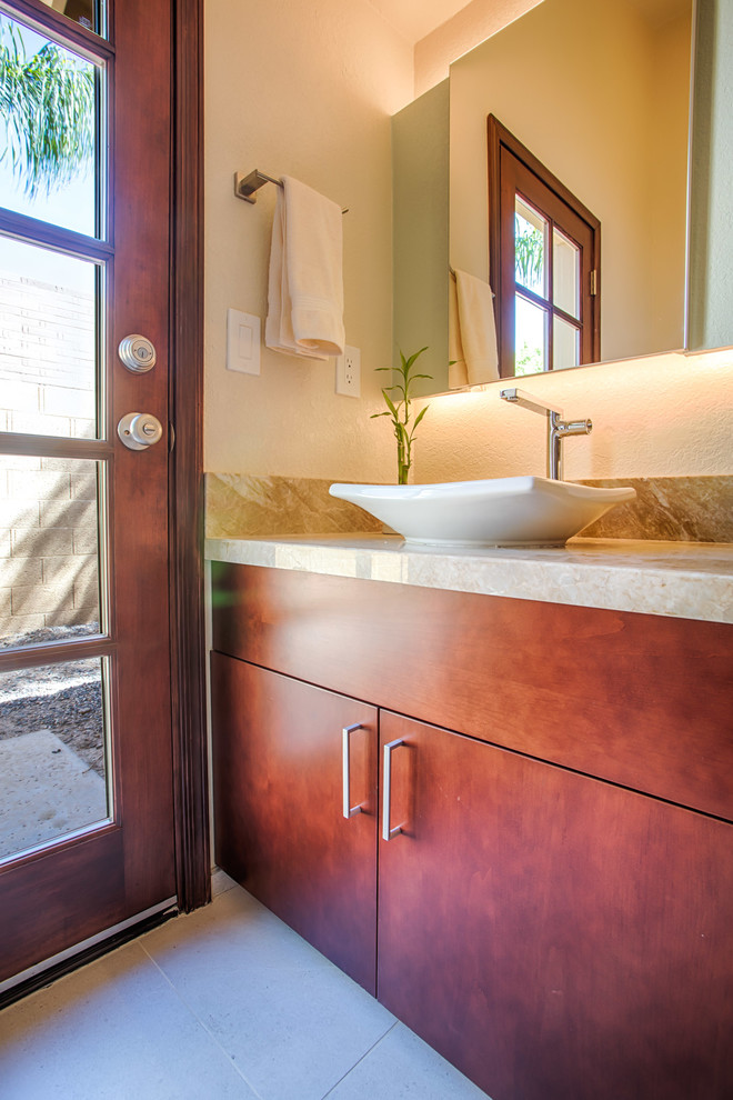 Alcove bathtub - small transitional beige tile and porcelain tile porcelain tile and beige floor alcove bathtub idea in Phoenix with flat-panel cabinets, medium tone wood cabinets, a one-piece toilet, beige walls, a vessel sink and granite countertops
