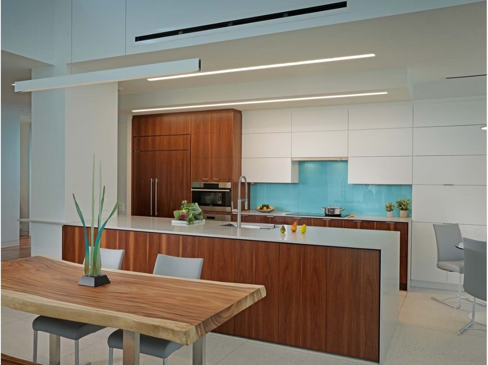 Design ideas for a mid-sized contemporary eat-in kitchen in Tampa with a single-bowl sink, flat-panel cabinets, medium wood cabinets, quartz benchtops, glass sheet splashback, panelled appliances, terrazzo floors, with island and white floor.