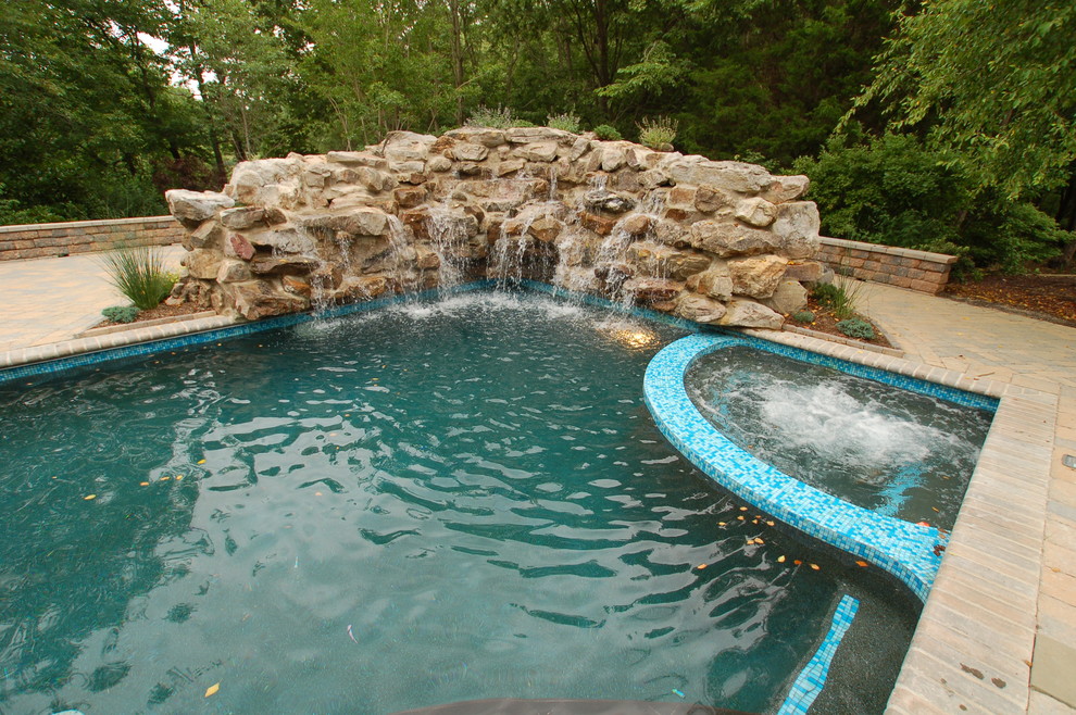 Inspiration for a large transitional backyard brick and rectangular lap hot tub remodel in Baltimore