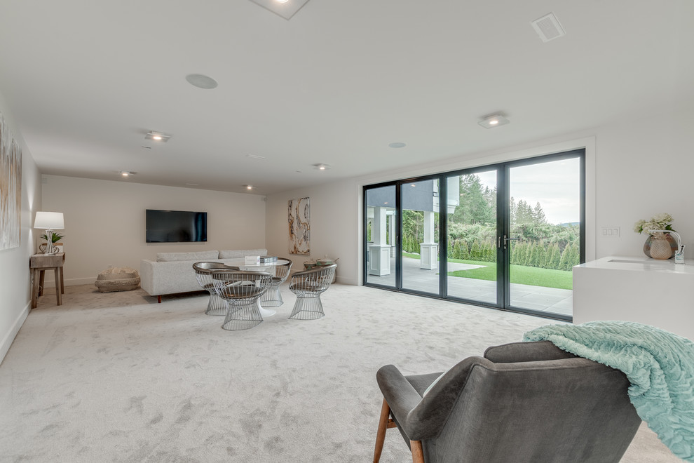 Photo of a large modern open concept family room in Vancouver with white walls, carpet, a wall-mounted tv and beige floor.