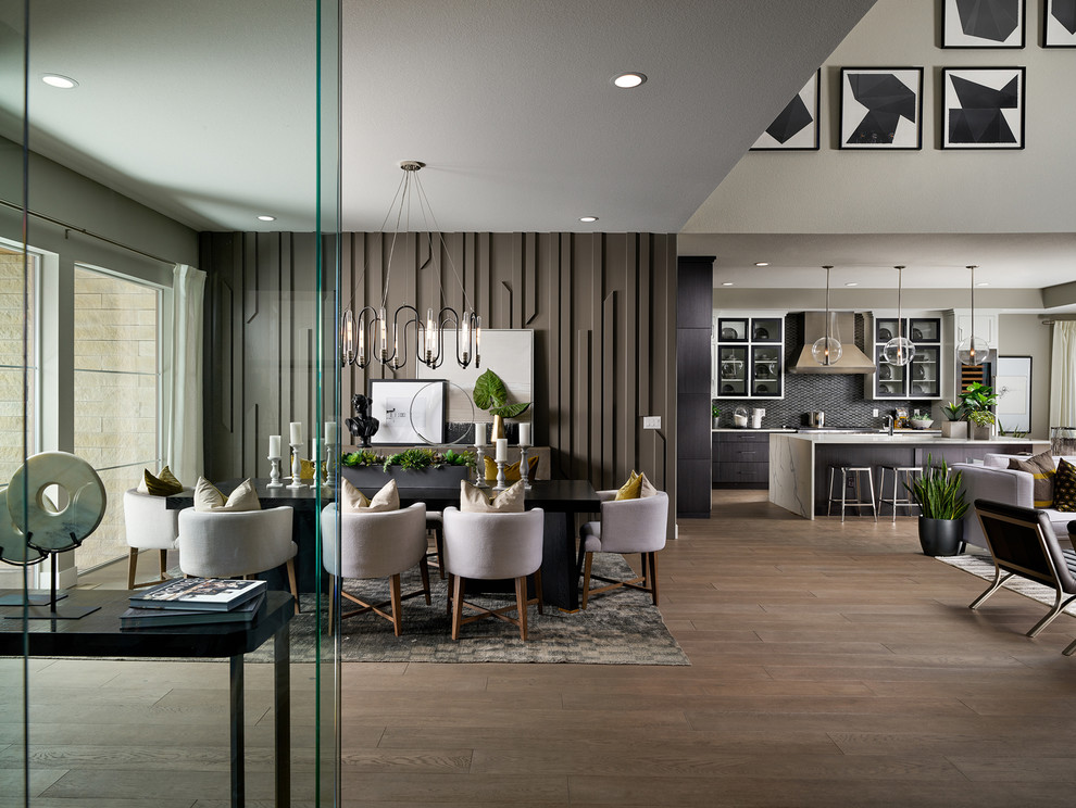 Example of a trendy medium tone wood floor and brown floor great room design in Denver with brown walls