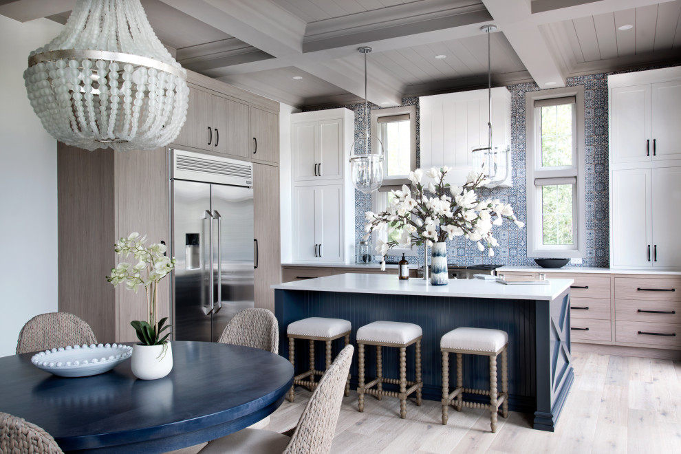 Design ideas for a large transitional eat-in kitchen in Ottawa with white cabinets, blue splashback, stainless steel appliances, light hardwood floors, with island, white benchtop, shaker cabinets and beige floor.