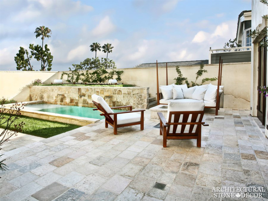 Inspiration for a mid-sized mediterranean backyard patio in Toronto with natural stone pavers and no cover.