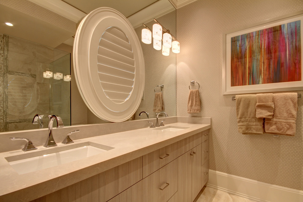 This is an example of a large traditional master bathroom in Miami with flat-panel cabinets, light wood cabinets, an alcove shower, a two-piece toilet, beige tile, limestone, beige walls, limestone floors, an undermount sink, limestone benchtops, beige floor and a hinged shower door.