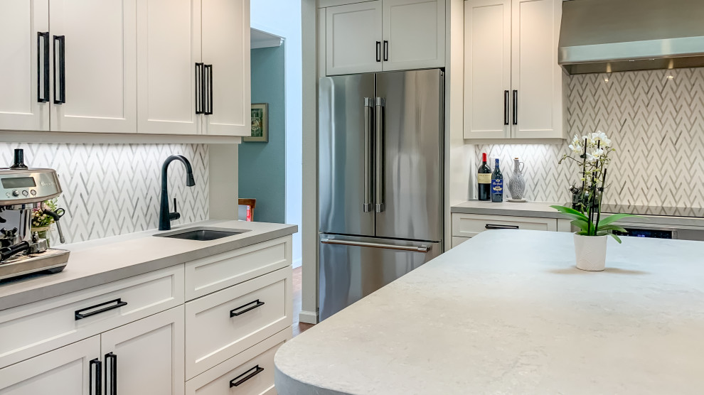 Inspiration for a classic u-shaped kitchen/diner in San Francisco with shaker cabinets, white cabinets, engineered stone countertops, white splashback, marble splashback, an island and grey worktops.