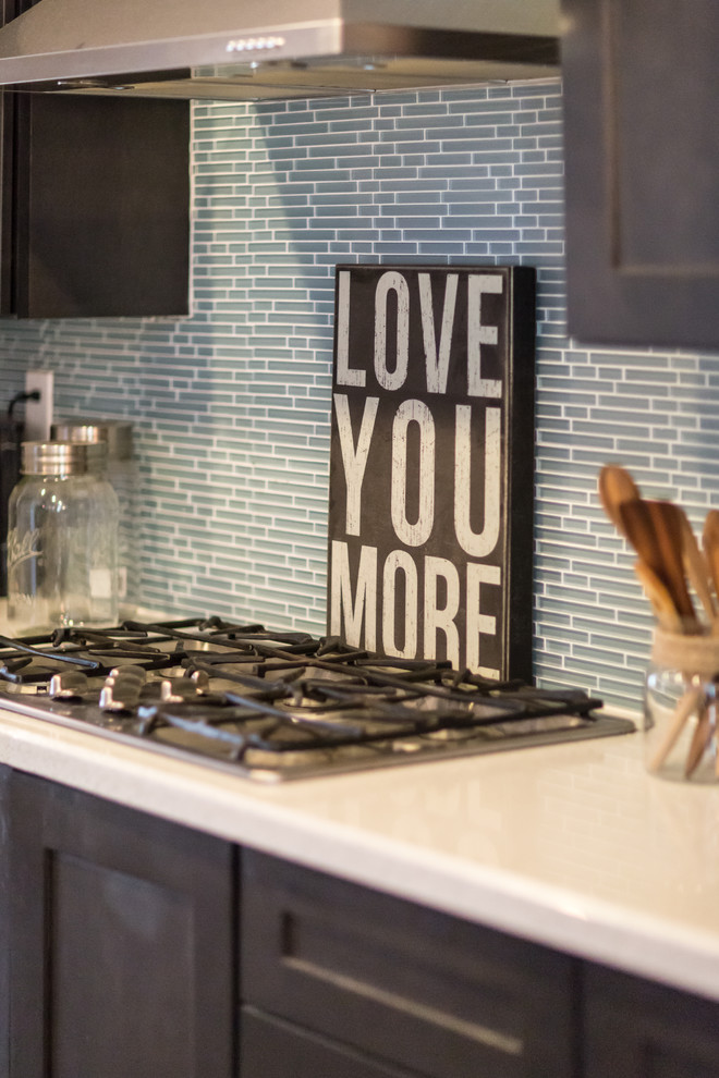 Open concept kitchen - mid-sized rustic single-wall concrete floor and gray floor open concept kitchen idea in Phoenix with dark wood cabinets, blue backsplash, stainless steel appliances, an island, an undermount sink, shaker cabinets, quartzite countertops and glass tile backsplash