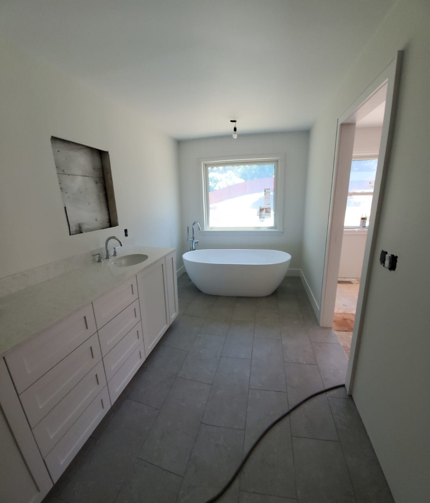 Large contemporary master bathroom in San Francisco with recessed-panel cabinets, white cabinets, a drop-in tub, pink tile, a drop-in sink, tile benchtops, pink benchtops, a double vanity and a built-in vanity.