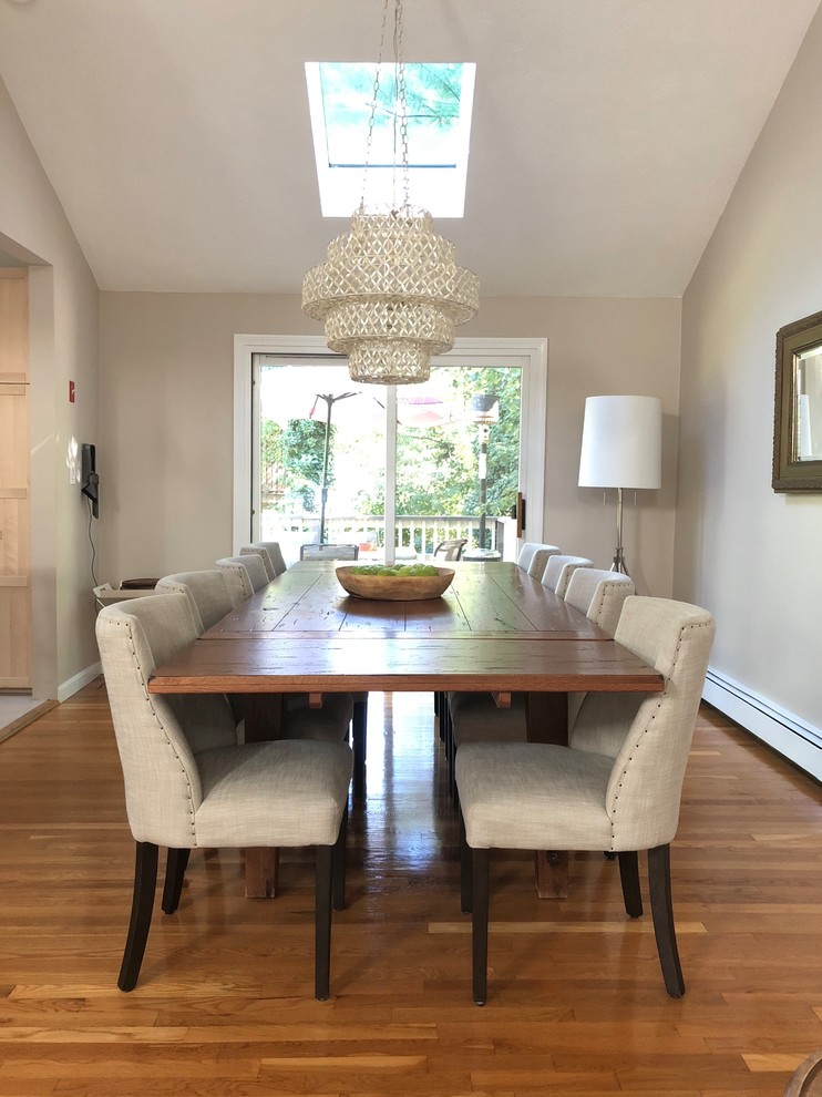 Transitional separate dining room in Boston with beige walls, medium hardwood floors and brown floor.
