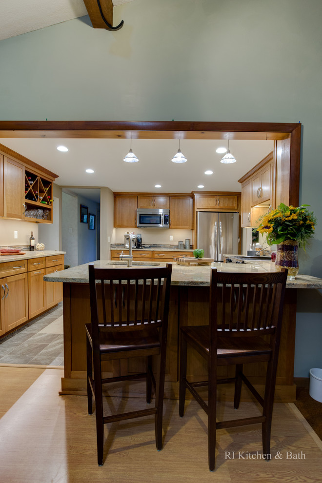 Example of a mid-sized transitional u-shaped porcelain tile enclosed kitchen design in Providence with an undermount sink, shaker cabinets, medium tone wood cabinets, granite countertops, multicolored backsplash, glass tile backsplash, stainless steel appliances and no island