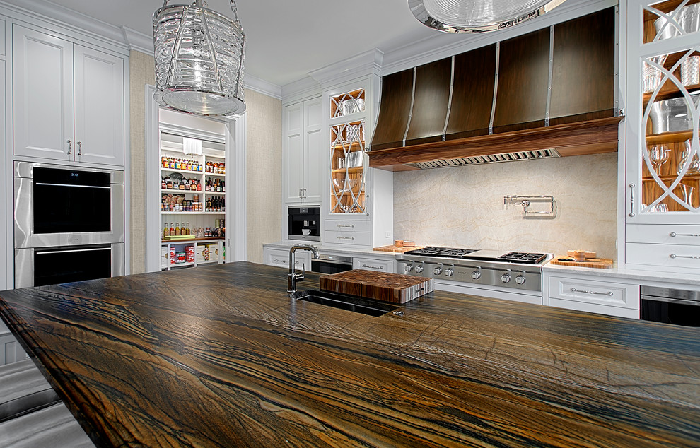 Inspiration for a large transitional dark wood floor kitchen remodel in Chicago with white cabinets, stone slab backsplash, stainless steel appliances, an island, an undermount sink, recessed-panel cabinets, beige backsplash and brown countertops