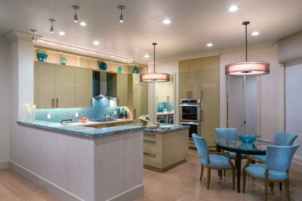 Photo of a mid-sized contemporary u-shaped open plan kitchen in Orange County with an undermount sink, flat-panel cabinets, beige cabinets, quartzite benchtops, glass tile splashback, panelled appliances, light hardwood floors, with island, blue splashback, brown floor and turquoise benchtop.