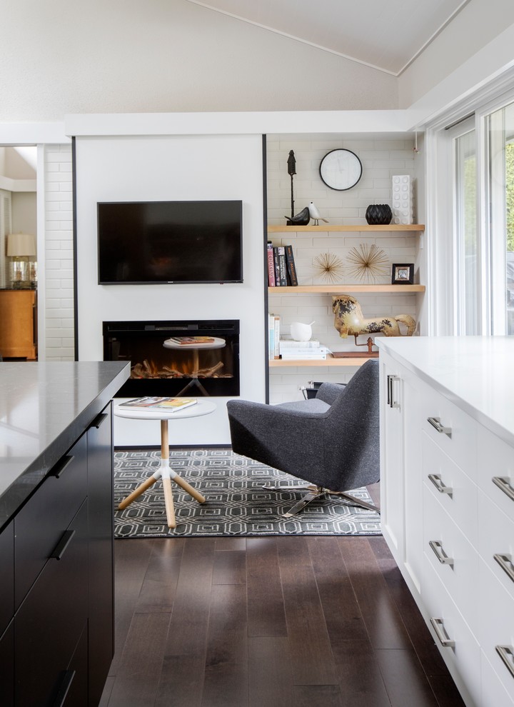 Design ideas for a small midcentury open concept family room in Vancouver with white walls, dark hardwood floors, a hanging fireplace, a plaster fireplace surround, a wall-mounted tv and brown floor.